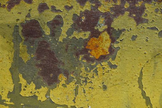 Stained corroded rusty yellow khaki painted metal surface with flakes and scratches