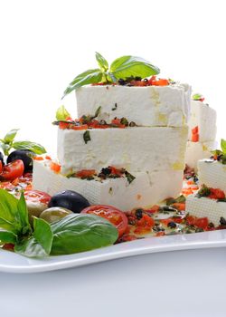 Pieces of feta   with basil and olives, cherry tomatoes