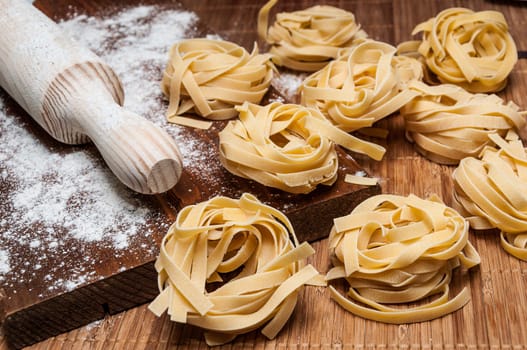 Homemade tagliatelle, flour and rolling pin