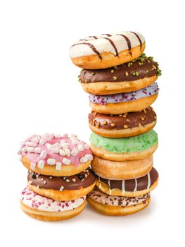 Photo of two stacks of donuts over white background. Shadow visible underneath.