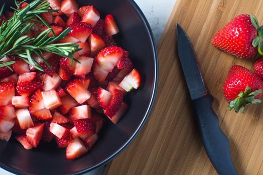 Bowl of freshly chopped red strawberry fruit