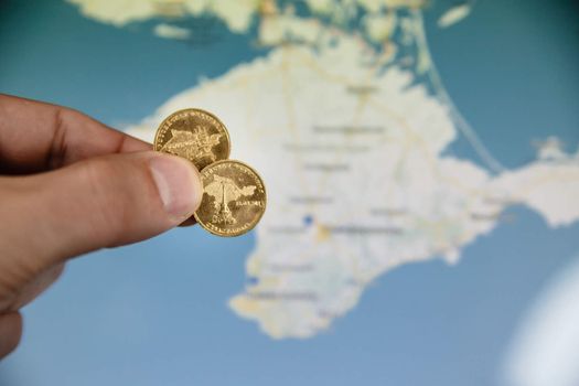 commemorative coin in honor of the Crimea to the Russian Federation with blurry crimea map in background