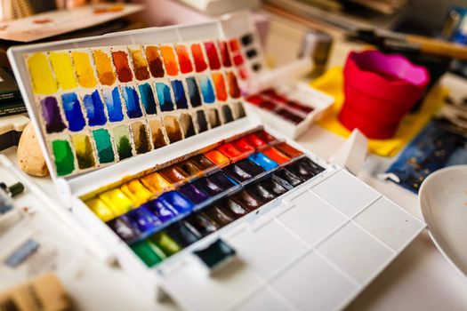 Box  of watercolors on working artist table