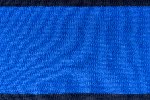 Knit woolen texture. Fabric blue background