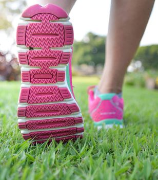 Woman walking on lawn