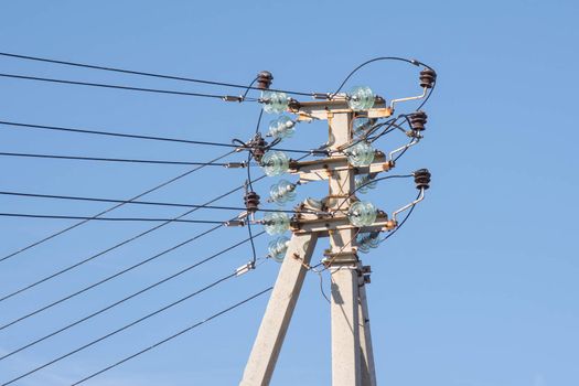 A pillar of power line installed on it, and isolated wires to prop up the pole