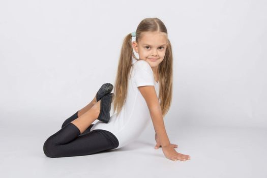 six year old girl aspiring gymnast performs a number of training exercises