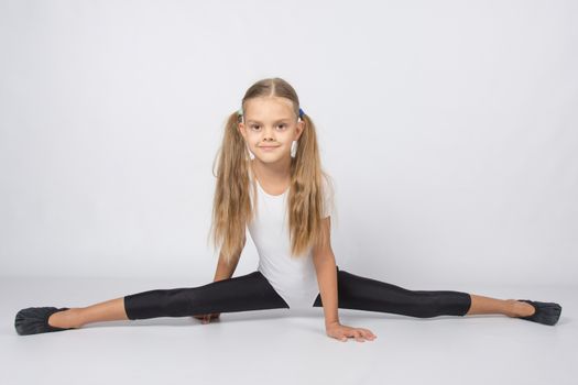 six year old girl aspiring gymnast performs a number of training exercises