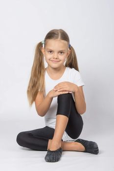 six year old girl aspiring gymnast performs a number of training exercises