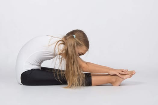six year old girl aspiring gymnast performs a number of training exercises