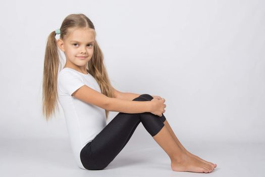 six year old girl aspiring gymnast performs a number of training exercises