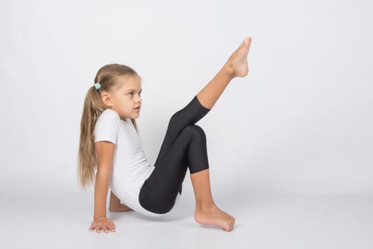 six year old girl aspiring gymnast performs a number of training exercises