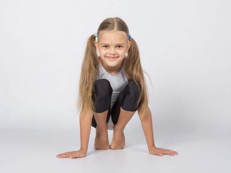 six year old girl aspiring gymnast performs a number of training exercises