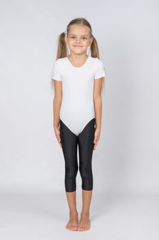 six year old girl aspiring gymnast performs a number of training exercises