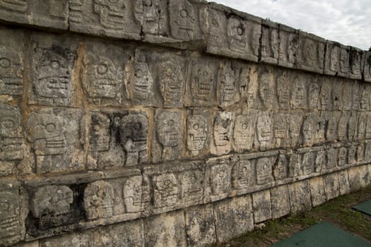 Mayan wall of carved stone skulls, Chichen Itza, Mexico