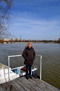 Woman sitting on a pontoon on the river Borcea