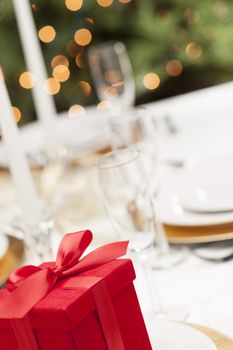 Beautiful Christmas Gift with Place Setting Abstract at Table.