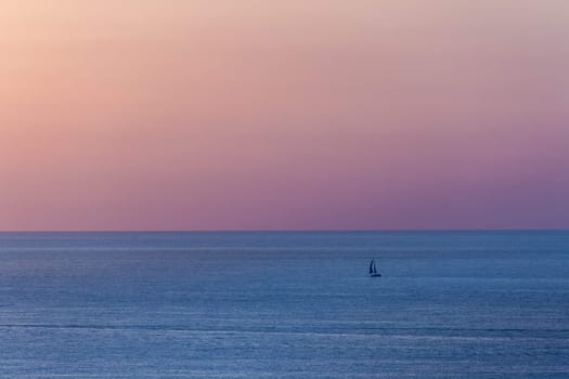 The boat on Mediterranean sea at sunset