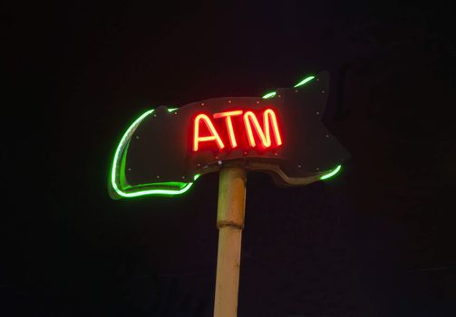 Neon ATM sign isloated on black background