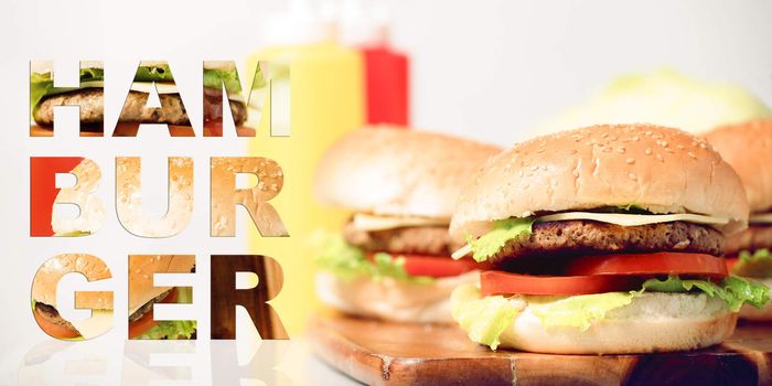 Hamburgers with cheese, potato chips and ingredients on a white background with typography