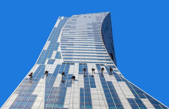 Special service team cleans the facade of the Orco Tower building designed by Daniel Libeskind, famous architect who also created the tower in place of WTC in NY.