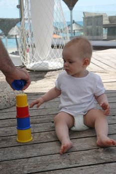 Baby girl playing in the beach cafe