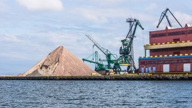 Heap of gravel on the quay, on July 10, 2013, in the Port of Gdynia - the third largest seaport in Poland, specialized in handling containers, ro-ro and ferry transport.