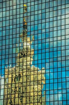 Palace of Culture and Science reflected in the widows of Marriott hotel, on March 01, 2013. Both buildings are the most recognizable landmarks of the capital of Poland.