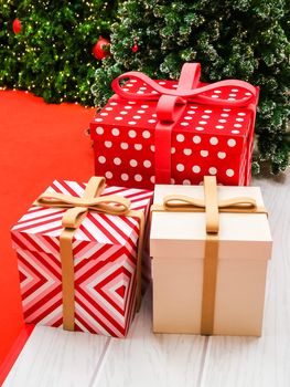 gift boxes on the floor by christmas tree