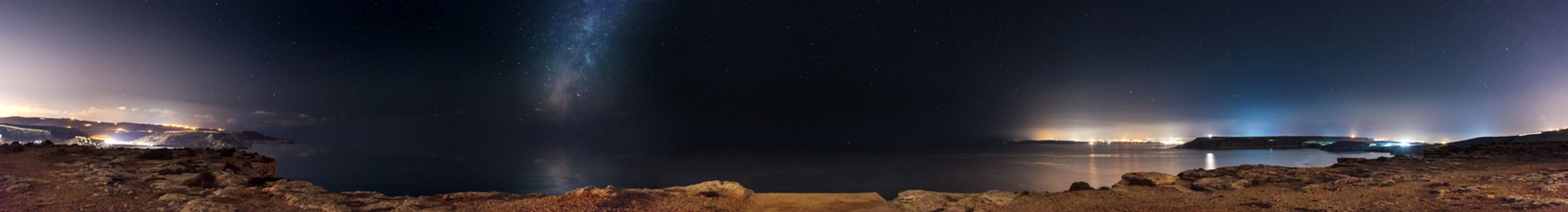 A full 180 degree panorama of the night sky view as seen from Majjistral Park in Malta