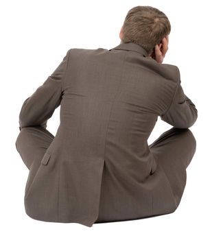 Businessman sitting in lotus posture on isolated white background, rear view