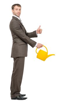 Businessman with watering-can and showing ok on isolated white background