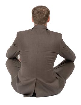 Businessman sitting in lotus posture on isolated white background, rear view