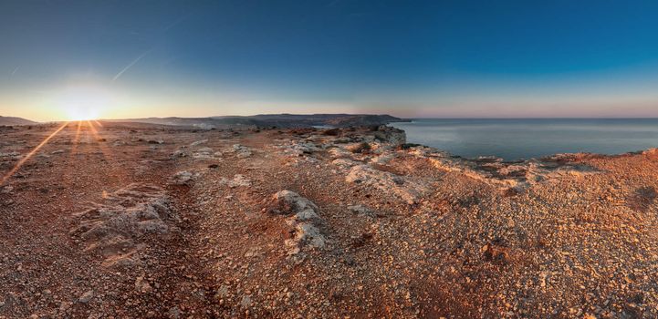 The terrain at Majjistral Park during sunrise.  One look at the stones and colour and you could easily think you're on Mars.