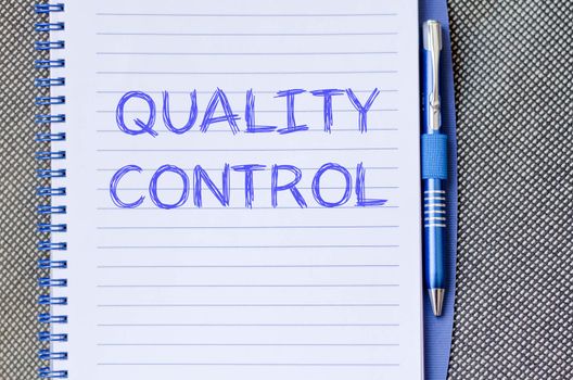 Quality control text concept write on notebook with pen