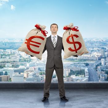 Businessman holding big moneybag with dollar and euro signs