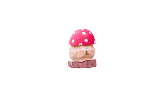 Fly agaric manufactured from wood against white background.