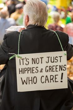 AUSTRALIA, Sydney: A man wears a sign that reads: It's not just hippies and greens who care' as tens of thousands of Sydney protesters call for a focus on the cost of climate change to Pacific Islands on November 29, 2015, just ahead of the COP21 conference on climate change.  Australia's climate-sensitive neighbours in the Pacific were the focus for the climate change rally in Sydney as representatives of communities from Pacific nations of Tuvalu, Nauru, Kiribati and Tonga attend the march from the Domain to Circular Quay.  Climate change rallies rolled on across Australia over the weekend in Melbourne, Darwin, Brisbane and an unusually high turnout marches in Canberra.  