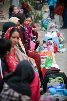 NEPAL, Patan: Nepalese women wait with empty gas tanks in Patan, Nepal on November 29, 2015 as fuel supplies dwindle. Blockades of major trade routes with India have continued after months of unrest over the nation's new constitution, opposing the demarcation of communities, and a perceived lack of representation in the constitution.