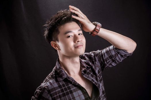 Portrait of Asian young man on black background -smily handsome young man