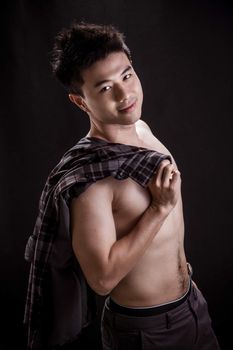 Portrait of Asian young man on black background -topless handsome young man