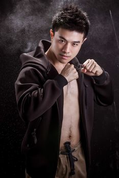 Portrait of Asian young man on black background - Fitness healthy guy and fighter concpet