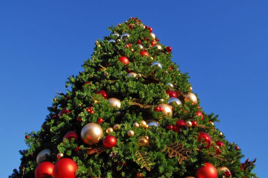 Big Christmas tree decorated with baubles and ornaments