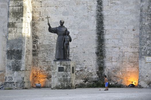 Havana, Cuba, August 2013.  Statue of St Francis of Assisi and small boy, Plaza de San Francisco in Old Habana.