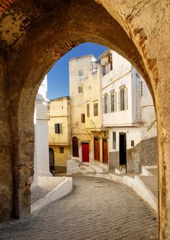 View to a narrow street through the city gate in Tangier, Morocco