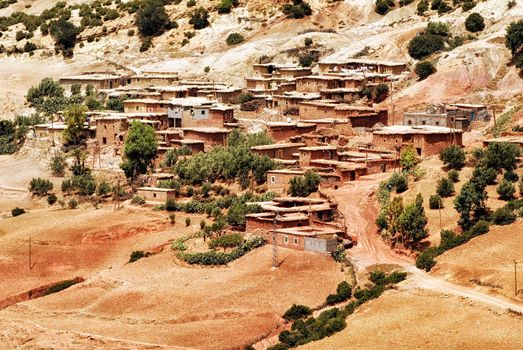 Red clay stone bedouin village in Atlas mountains, Sahara, Morocco