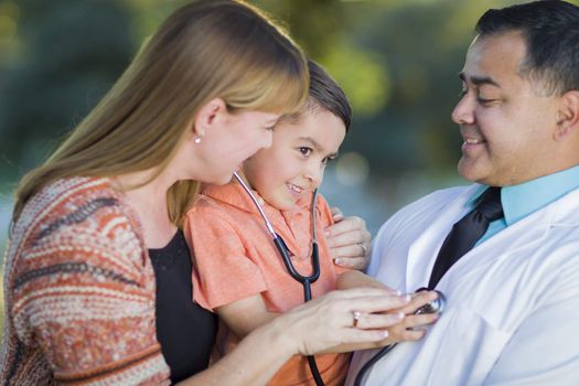Happy Mixed Race Boy, Mother and Hispanic Doctor Having Fun With Stethoscope Outdoors.