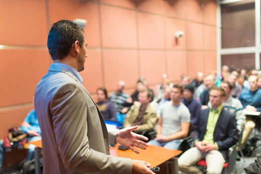 Speaker at Business Conference with Public Presentations. Audience at the conference hall. Business and Entrepreneurship concept. Background blur. Shallow depth of field.