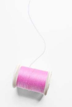 pink thread on white background