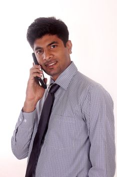 young businessman talking on mobile phone in office